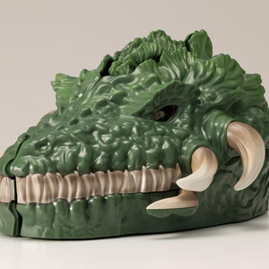 Closed Biollante pocket toy side view showing plant beast head sculpt and tusks.