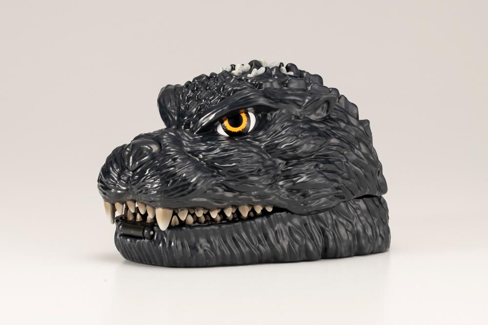 Closed Godzilla head pocket playset side view showing textured skin and teeth.