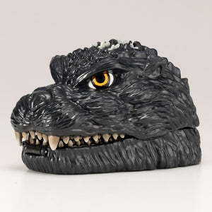 Closed Godzilla head pocket playset side view showing textured skin and teeth.