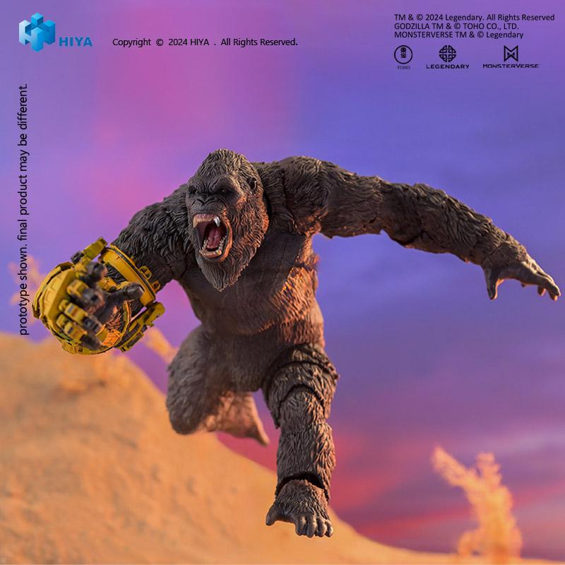 Dynamic leaping action pose of HIYA Exquisite Basic Kong figure charging forward with open jaws against desert background.