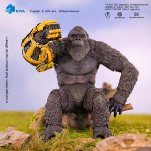 HIYA Exquisite Basic Kong action figure seated on a rock showcasing the detailed yellow armor gauntlet.