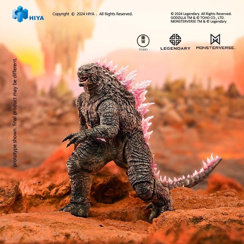 Dynamic low-angle profile of HIYA Exquisite Basic Godzilla Evolved action figure crouching on rocky terrain.