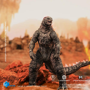 Front view of HIYA Exquisite Basic Godzilla Evolved action figure walking forward in a rocky landscape setting.