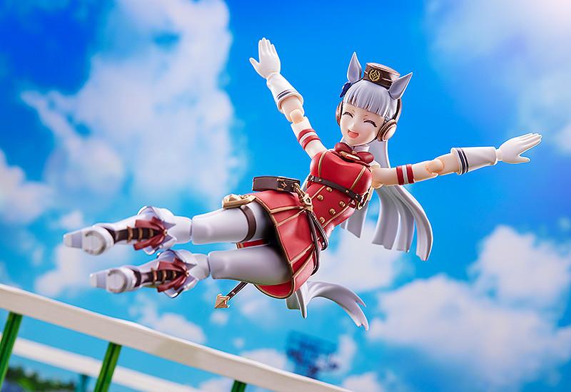Gold Ship action figure performing her signature mid-air dropkick pose against a blue sky background.