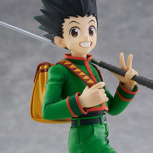Close-up studio portrait of the Gon Freecss anime figure focusing on his wide cheerful smile, big brown eyes, and green uniform collar.