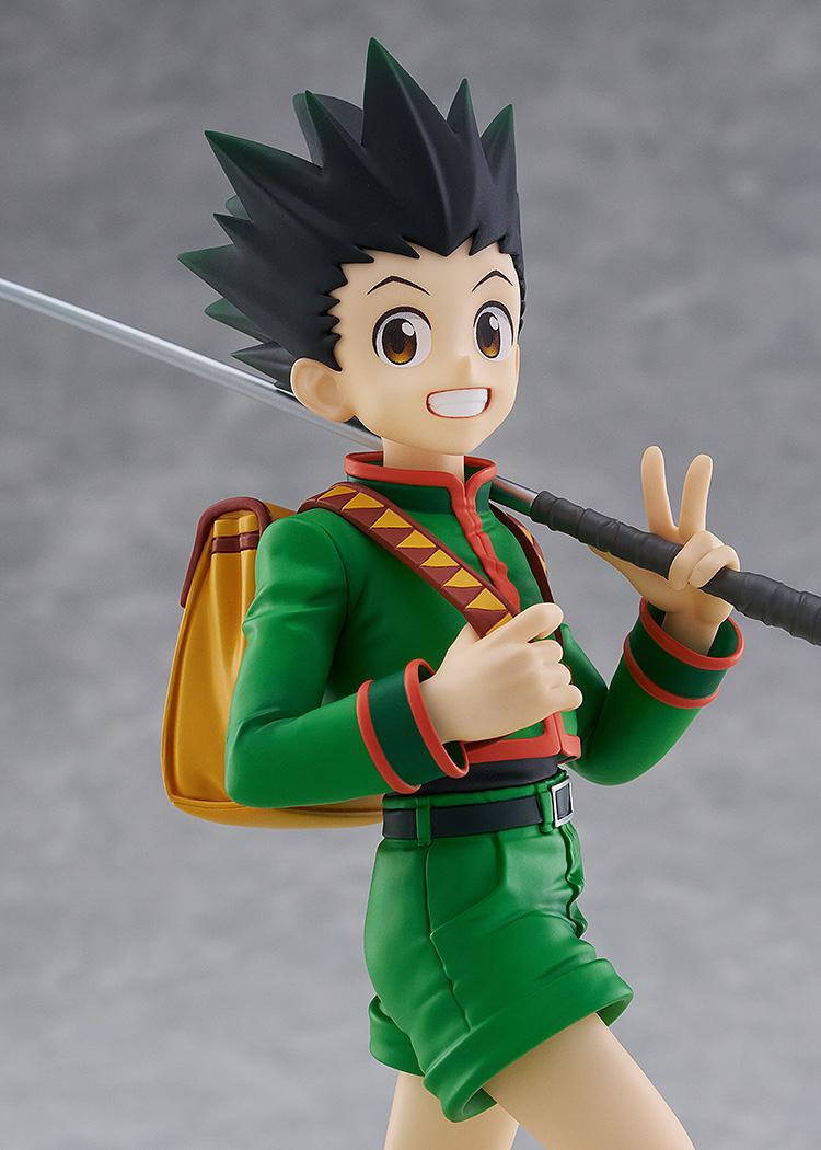 Close-up studio portrait of the Gon Freecss anime figure focusing on his wide cheerful smile, big brown eyes, and green uniform collar.