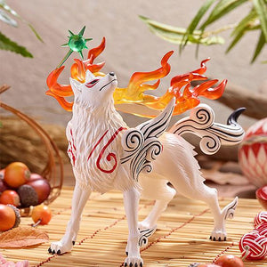Lifestyle product display of the Pop Up Parade Amaterasu figure placed on a traditional bamboo mat surrounded by autumn acorns and decorative cords.