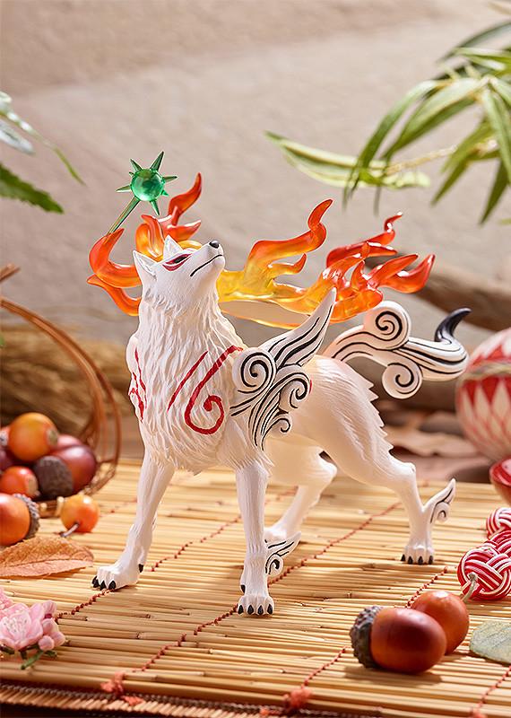 Lifestyle product display of the Pop Up Parade Amaterasu figure placed on a traditional bamboo mat surrounded by autumn acorns and decorative cords.