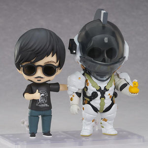 Hideo Kojima Nendoroid in sunglasses posed side-by-side with Nendoroid Ludens figure holding a mini yellow duck.