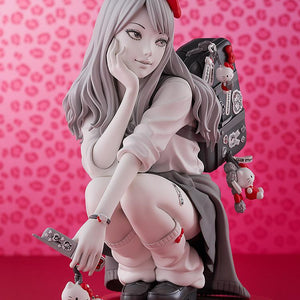 Vertical promotional shot of the Gyaru Tomie figure holding her decorated flip phone next to a pink leopard backdrop.