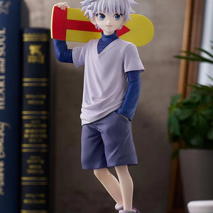 Full view of the Killua Zoldyck figure, showing the dynamic lean of his pose and the display setting with books.