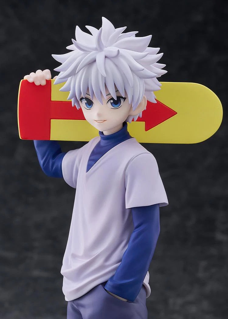 A close-up of the Killua Zoldyck figure, focusing on his smiling face and the red and yellow arrow design on the skateboard accessory.