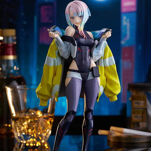 The Lucy figure standing on a mirrored base in a dramatic Night City bar diorama scene with neon lights and a full moon background.