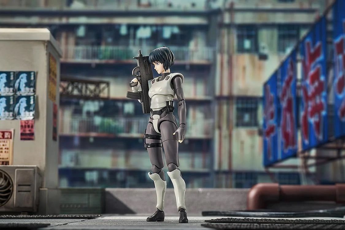 Motoko Kusanagi figure in a city street diorama, standing ready with her submachine gun in a detailed urban setting.