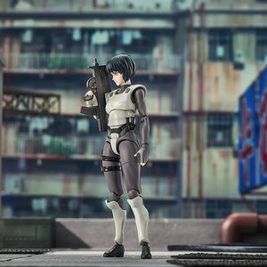 Motoko Kusanagi figure in a city street diorama, standing ready with her submachine gun in a detailed urban setting.