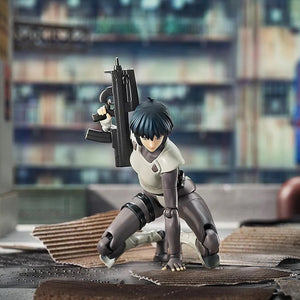 Motoko Kusanagi figure crouching on the ground in an action scene, aiming her submachine gun in an urban environment.
