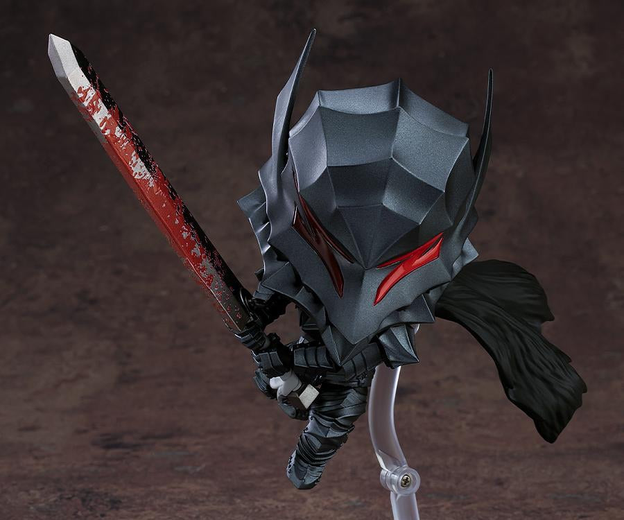 A close-up of the Guts Nendoroid figure's Berserker Armor helmet, highlighting the textured dark gray finish and the red eyes/visor.