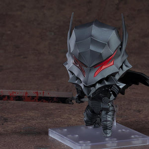 The Guts Nendoroid figure in the Berserker Armor, holding the Dragon Slayer sword, emphasizing the painted blood splatter effect on the blade.