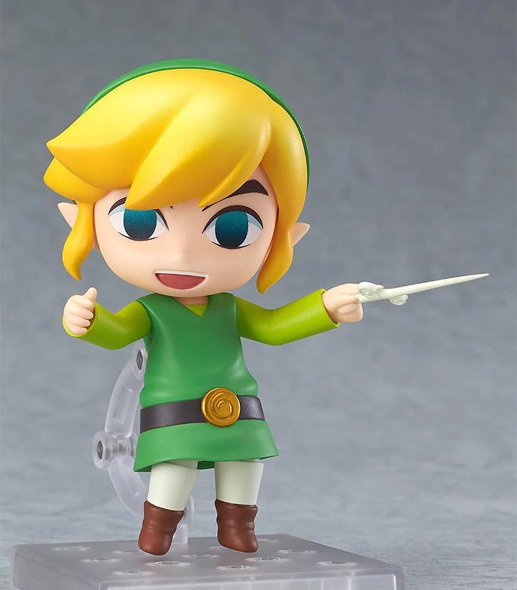 The Nendoroid Link figure featuring the cheerful smiling face plate, posed holding the Wind Waker baton accessory.