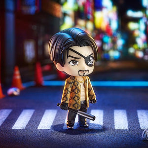 Majima Nendoroid figure standing in a dimly lit street diorama, holding the metal bat, capturing a moody Yakuza atmosphere.