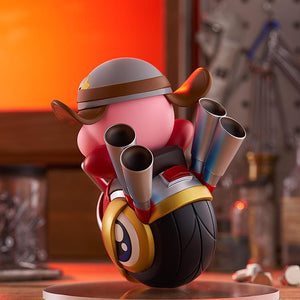 Back-right angle of the Kirby Wheelie Rider figure under warm lighting, detailing the dual metallic blue exhaust pipes and the textured black tire.