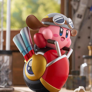 Close-up shot of the non-articulated Kirby Wheelie Rider figure in a workshop setting, focusing on his classic pink design, goggles, and the front wheel eye detail.