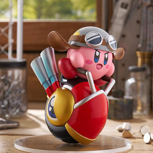 The Pop Up Parade Kirby Wheelie Rider figure posed in a sunny workshop setting, showcasing the metallic paint details on the wheelie's exhausts and Kirby's helmet.