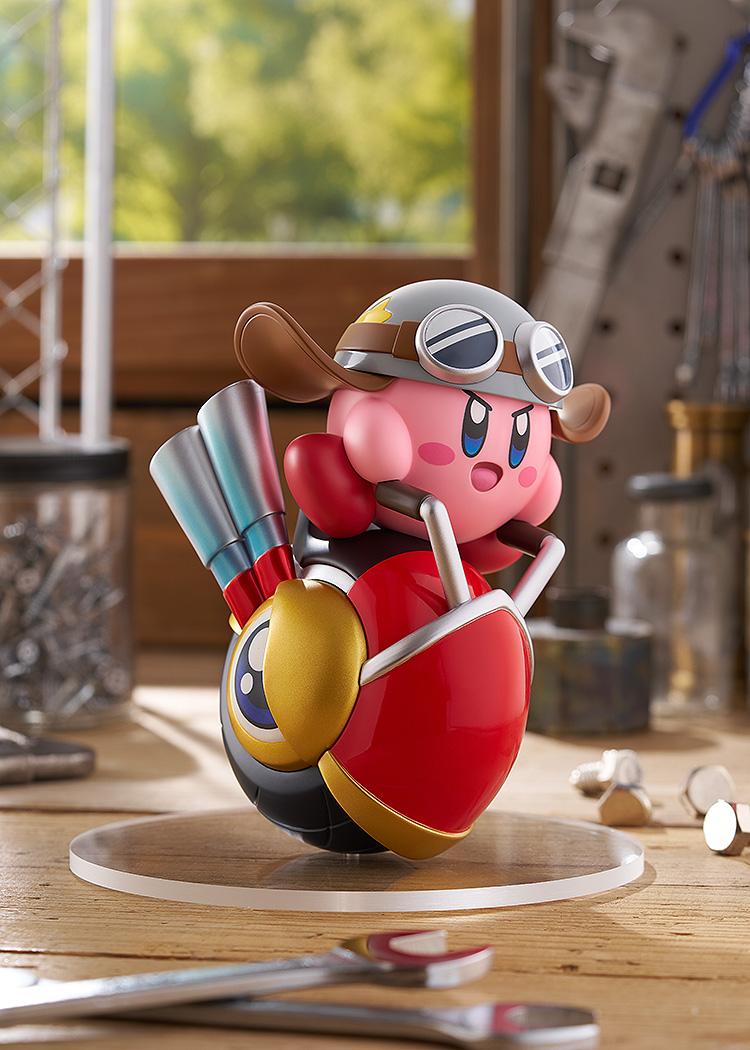 The Pop Up Parade Kirby Wheelie Rider figure posed in a sunny workshop setting, showcasing the metallic paint details on the wheelie's exhausts and Kirby's helmet.