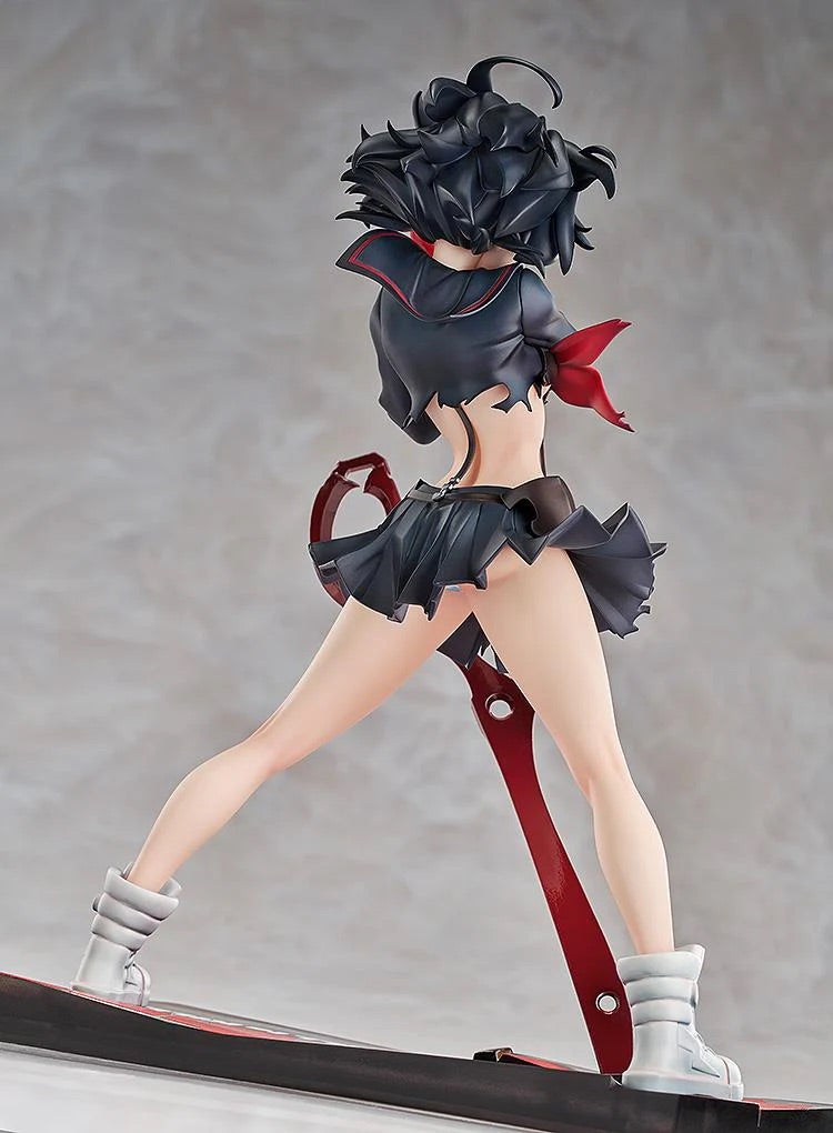 Rear view of the Ryuko Matoi figure, highlighting the dynamic flow of her skirt and hair, and the back of the Scissor Blade on the base.