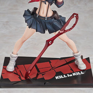 A close-up of the figure's legs, white boots, and the custom base featuring the cracked KILL la KILL logo design.