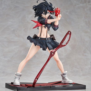 A full-body shot of the Ryuko Matoi figure in her uniform, with the red Scissor Blade resting on the battle-damaged base.