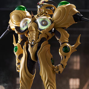 The Guyver Gigantic figma displaying the Giga-Smasher attack with its chest plates open, revealing glowing green orbs in a ruined city.