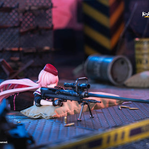 NTW-20 action figure in a prone sniper position, resting her rifle on a sandbag to take aim in an industrial scene.