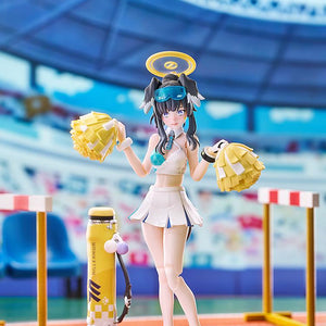 Embarrassed blushing face pose of Hibiki in her cheerleader outfit, displayed against a vibrant stadium backdrop.