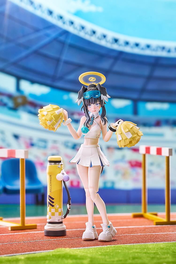 Embarrassed blushing face pose of Hibiki in her cheerleader outfit, displayed against a vibrant stadium backdrop.