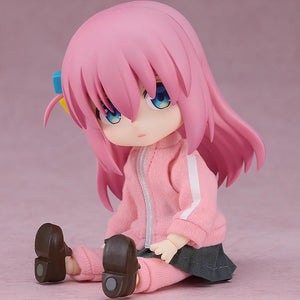 Anxious sitting pose of the Hitori Gotoh Nendoroid Doll figure on a pink backdrop, highlighting the highly flexible and articulated doll body.