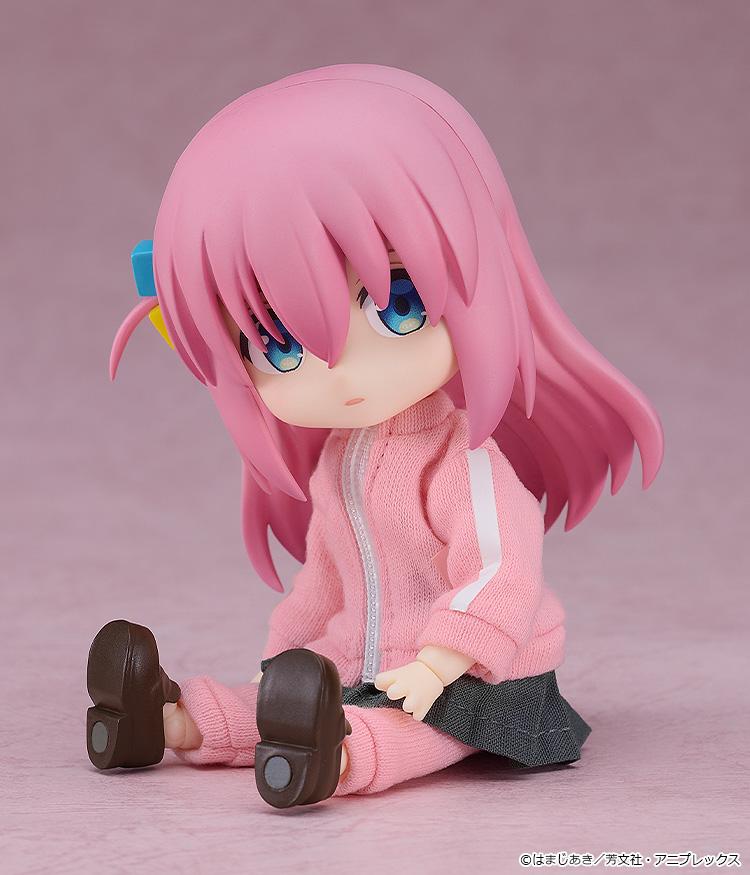 Anxious sitting pose of the Hitori Gotoh Nendoroid Doll figure on a pink backdrop, highlighting the highly flexible and articulated doll body.