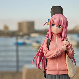 High-angle shot of the Hitori Gotoh figure standing outdoors with a blurred city and harbor background.