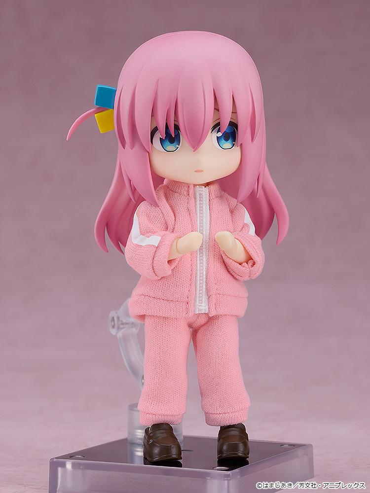 Hitori Gotoh Nendoroid Doll anime figure dressed up in her full signature pink fabric tracksuit outfit including matching zip-up top and pants.