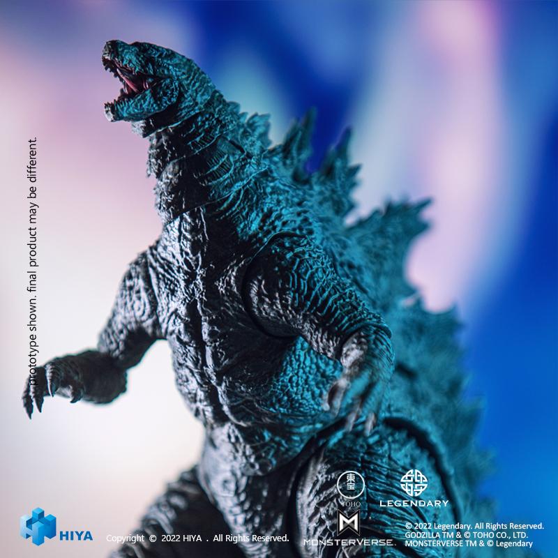 Medium shot of HIYA Exquisite Basic Godzilla vs. Kong figure in combat stance illuminated by blue cinematic backdrop lighting.