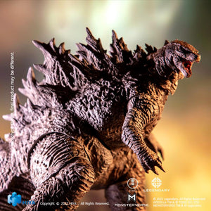 Dramatic profile close-up view of HIYA Exquisite Basic Godzilla 2021 action figure under warm lighting effects.