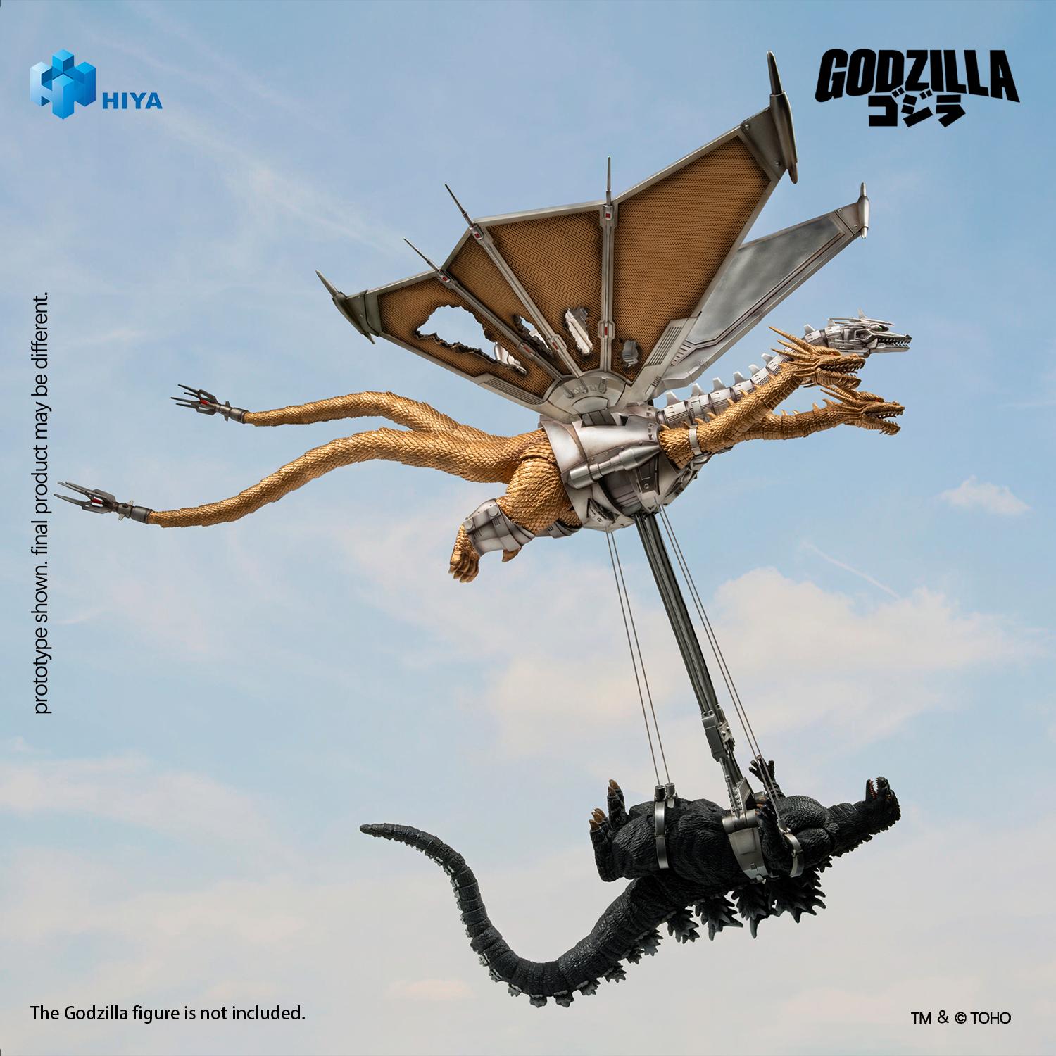 Mecha-King Ghidorah in an aerial flight pose lifting Godzilla with mechanical capture arms and cables.