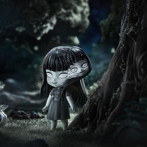 Atmospheric night scene of Tomie Nendoroid with multiple faces next to a large tree and mysterious bag.