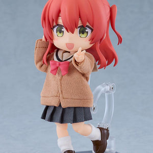 Articulated Ikuyo Kita Nendoroid Doll figure smiling while flashing a single peace sign, showcasing the high-quality fabric texture of her school sweater and pleated skirt.