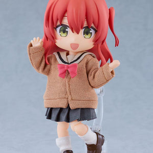 Full-body standing shot of the Ikuyo Kita Nendoroid Doll anime action figure waving cheerfully while mounted on a clear plastic display stand against a soft grey studio background.