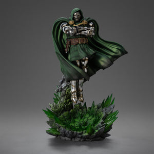 Full front view of the Iron Studios Doctor Doom 1/10 Scale Statue, showing him hovering over a base of glowing green rock and crystal.