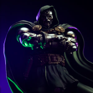 A highly focused close-up of Doctor Doom's metal face mask and the gold clasps on his green cape.