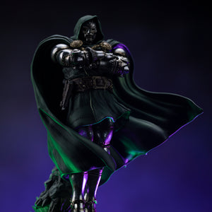 A dramatic low-angle shot of the Doctor Doom statue, highlighting the reflective nature of his armor and the sweeping green cloak.