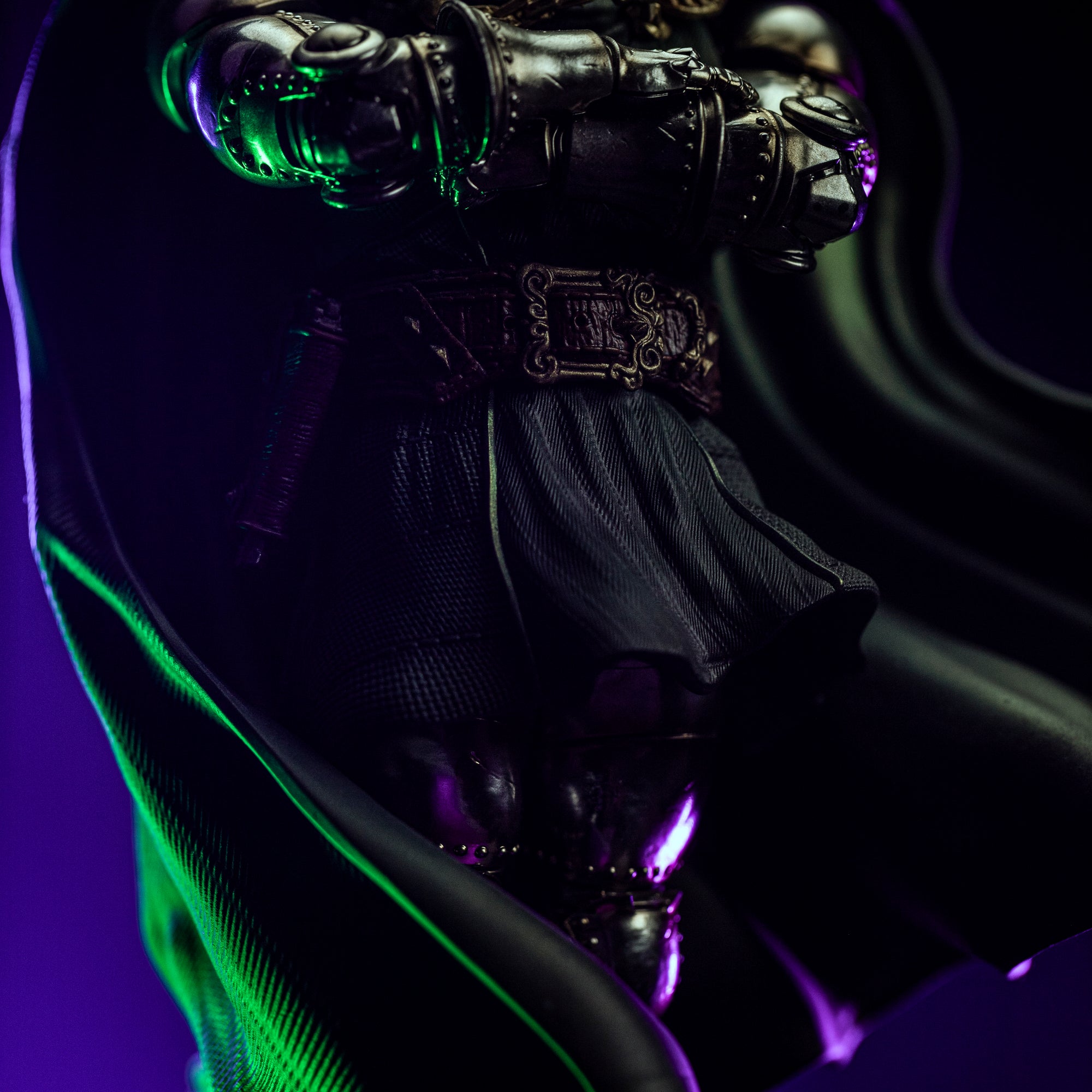 A close-up of Doctor Doom's lower torso, focusing on the dark green fabric of his tunic, his ornate belt, and the armored gauntlets.