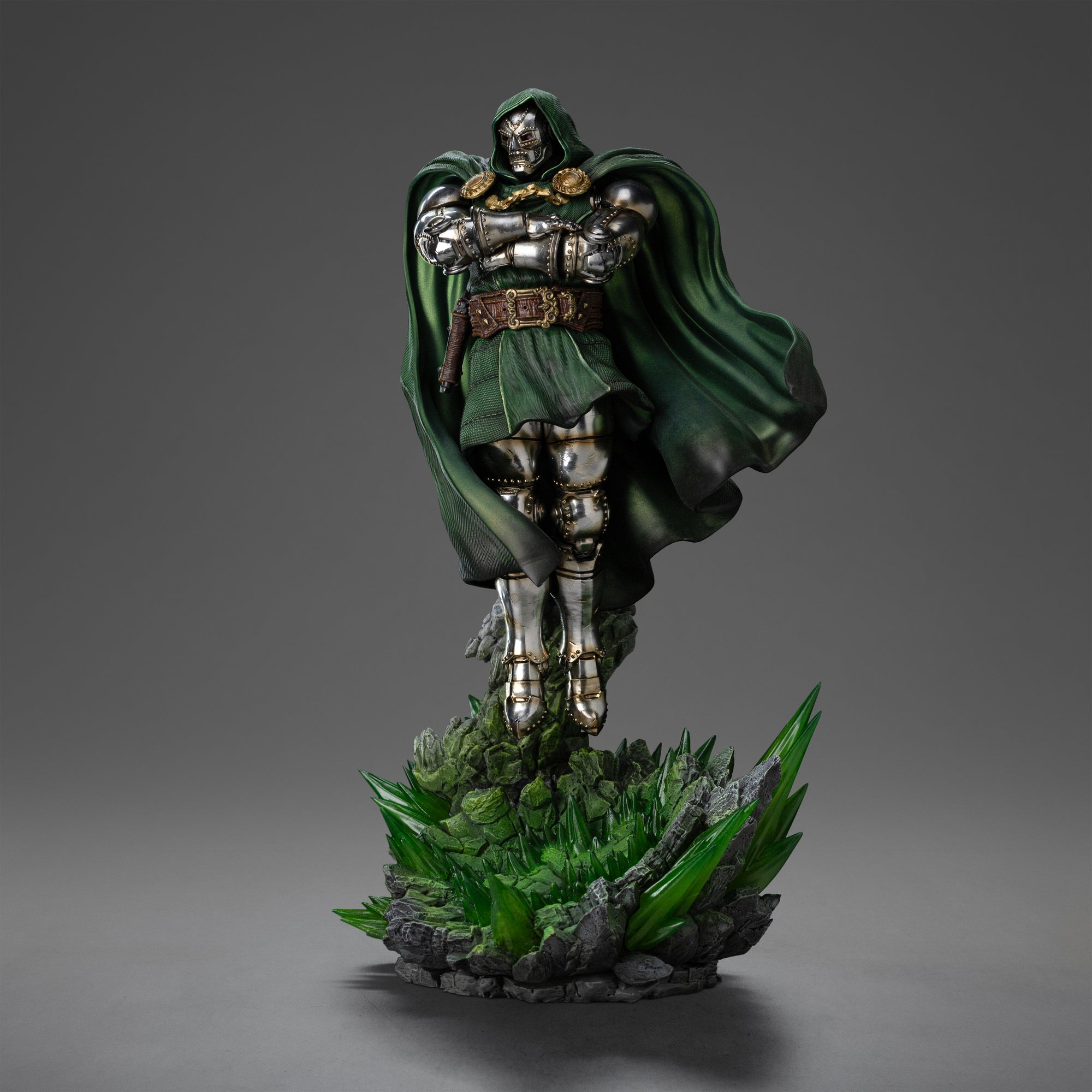 A front right view of the Doctor Doom statue, showing him floating with his cape billowing and a skull sculpted into the base behind him.